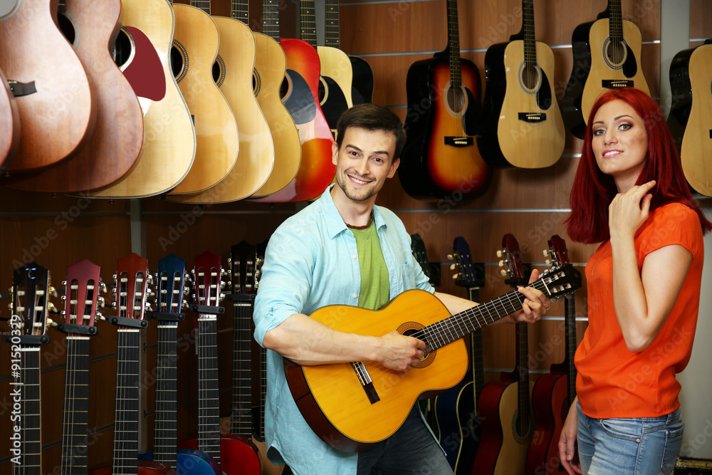 Beautiful young couple in music store