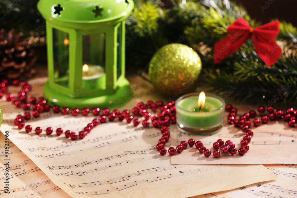 Christmas decorations on music sheets, closeup