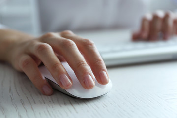 Sticker - Female hand with computer mouse on table, closeup