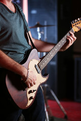 Poster - Young man playing on electric guitar close up