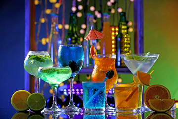 Wall Mural - Glasses of cocktails on bar background