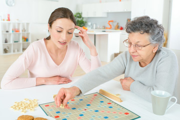 Elderly woman playing a board game