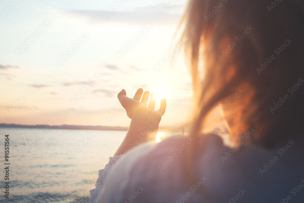 woman try to grab the sun - obrazy, fototapety, plakaty 