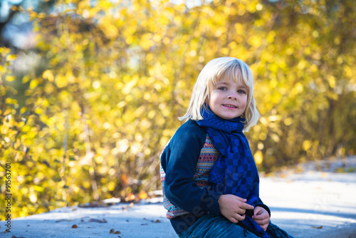 Portrait of adorable cute boy in the beauty autumn park Poster Mural XXL