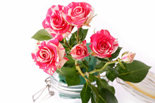 Bouquet Of Roses In A Glass Jar On A White Background