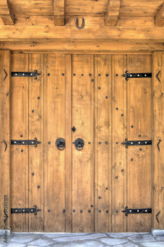 Naklejka na szybę Stylish wooden door with metal ornaments closeup