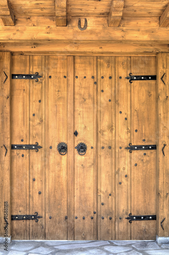 Tapeta ścienna na wymiar Stylish wooden door with metal ornaments closeup