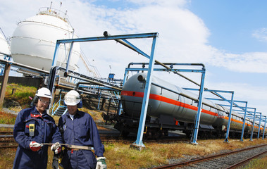 Wall Mural - oil and gas workers with train loaded with crude oil and fuel