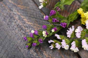 Poster - Beautiful wild flowers on wooden table close up