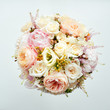 Elegant flower bouquet of roses in light colors and pearl beads decoration.