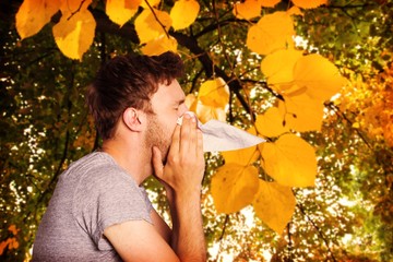 Poster - Composite image of close up side view of man blowing nose