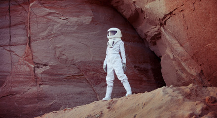 Wall Mural - futuristic astronaut on another planet, image with the effect of