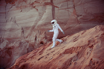 Wall Mural - futuristic astronaut on another planet, image with the effect of