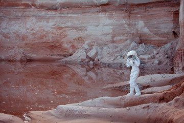 Wall Mural - futuristic astronaut on another planet, image with the effect of