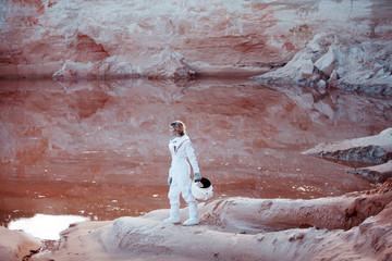 Wall Mural - futuristic astronaut on another planet, image with the effect of
