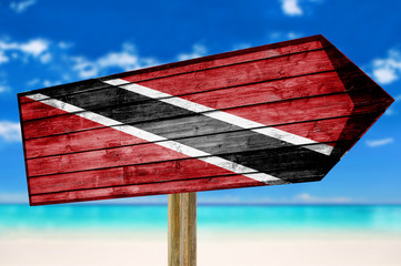 Trinidad and Tobago Flag wooden sign on beach background