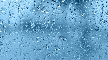 Raindrops on the window. Blue tone