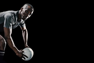 Wall Mural - Composite image of rugby player looking away while holding ball