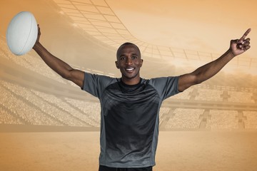 Wall Mural - Composite image of confident sportsman with arms raised