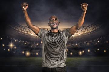 Wall Mural - Composite image of happy sportsman with clenched fist