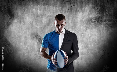 Cuadros en Lienzo Composite image of rugby player holding ball