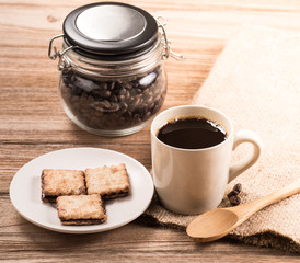 Coffee cup and saucer on a wooden table.