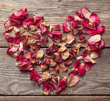Dried Rose Petals On Wooden Table