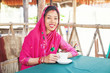 nepali woman drinking coffee or tea