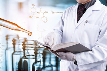 scientist reading text book with laboratory background 