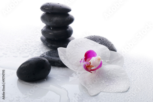 Obraz w ramie White Orchid and spa stones on a white background