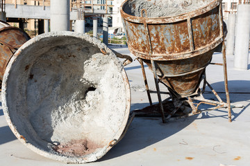 two old huge rusty concrete mixers