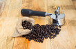 An espresso machine group head  and coffee beans in sacks.