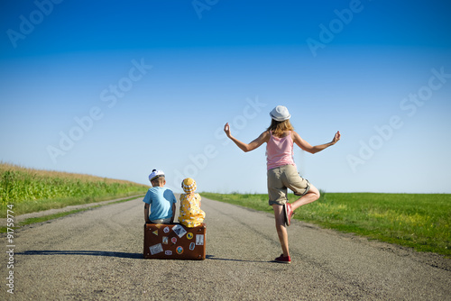 Fotografia, Obraz Young woman meditating near two children on summer country road