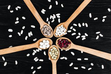 Wall Mural - A colorful of beans in wood spoon on wood background