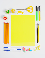 School Supplies Around Yellow Paper