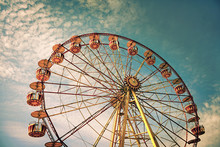 Yellow Ferris Wheel Against A Blue Sky In Vintage Style