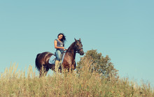 Portrait Of A Beautiful Young Woman Riding A Horse.