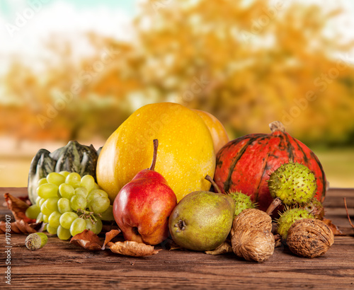 Fototapeta na wymiar Fall fruit and vegetables on wood. Thanksgiving concept