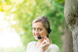 Business woman talking using her headset in the park