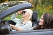 © fizkes - Young women travelling in a car