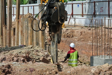 Retaining wall steel sheet pile installation by machine