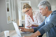 © goodluz - Senior couple at home checking expenses on internet