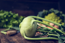 Fresh Organic Kohlrabi On Rustic Kitchen Table With Garden Vegetables 