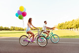 Fototapeta Do pokoju - happy smiling couple ride bicycles have fun