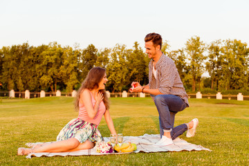 Canvas Print - young man makes a proposal of betrothal to his girlfriend