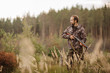 © kaninstudio - Young male hunter in camouflage clothes ready to hunt  with hunt