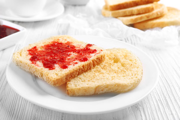 Wall Mural - Bread with homemade jam in plate on wooden table, closeup