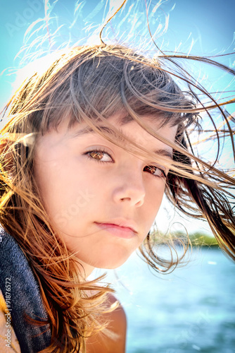 Fotografia, Obraz Portrait of a beautiful eight year old girl with the wind blowin