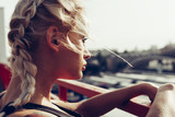 Young woman with braided pigtails. Soft sunny colors.