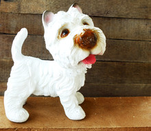 Ceramic Welcome Dog On Wooden Background Still Life